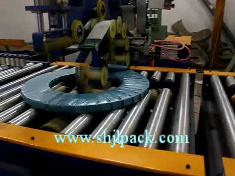 Coil packing machine for automatic wrapping and taping. Optimized to reduce title length to 9 words.