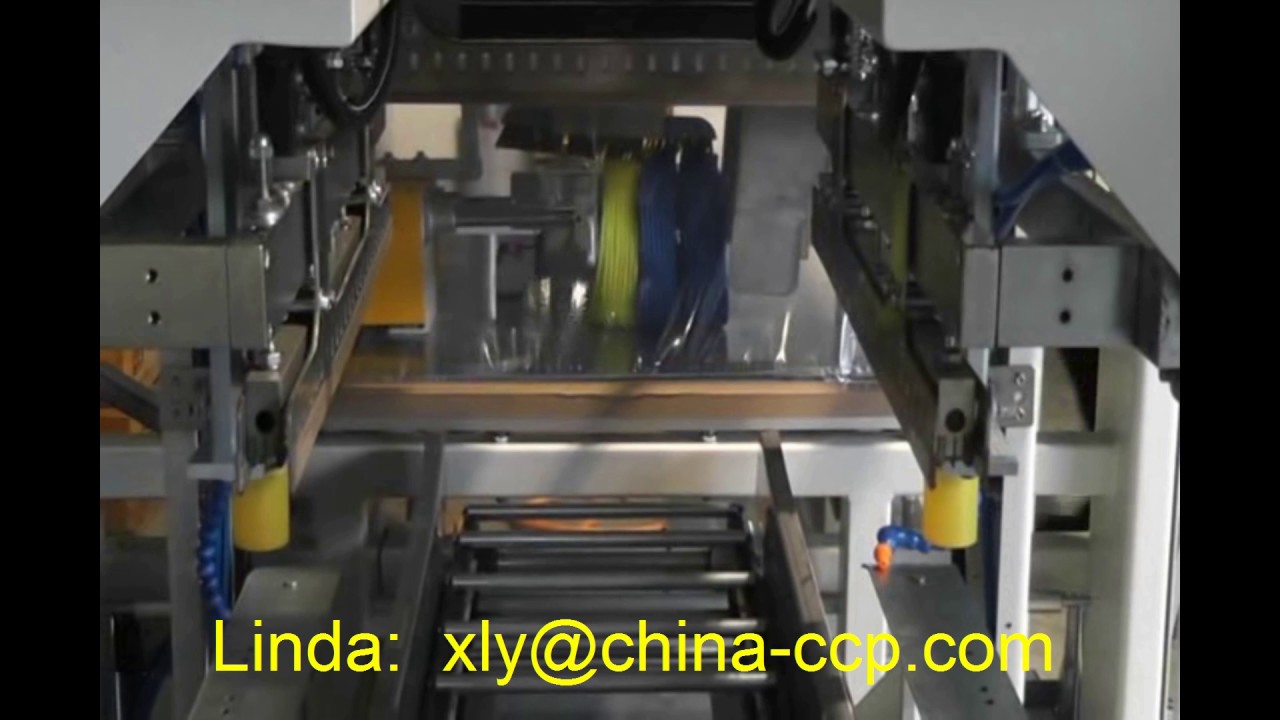 Coil packing machine with optimized PE film four-side sealing sleeve packaging, reduced to under 35 words.