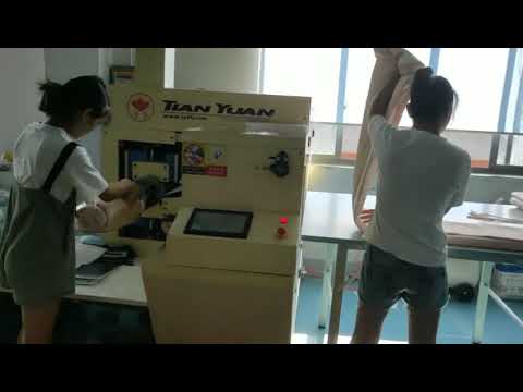 Compact packing machine for duvet blankets using coils and rolls.