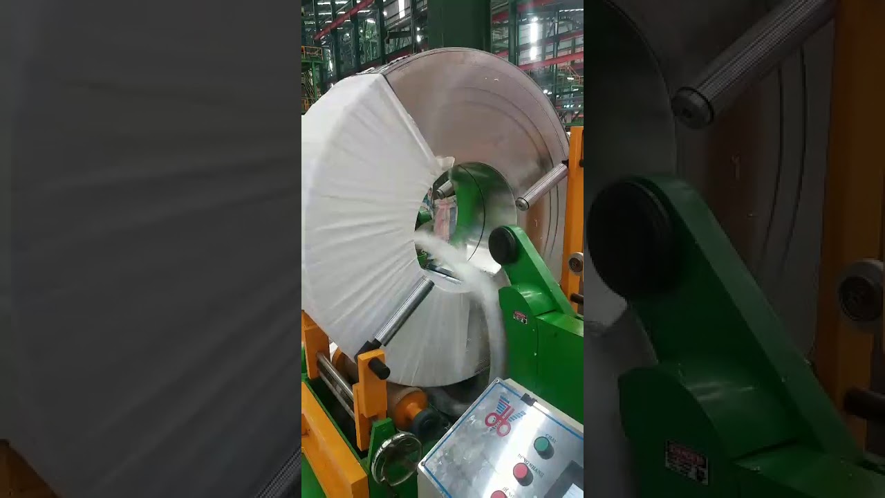 Compact steel coil packaging machine for efficient and safe wrapping.