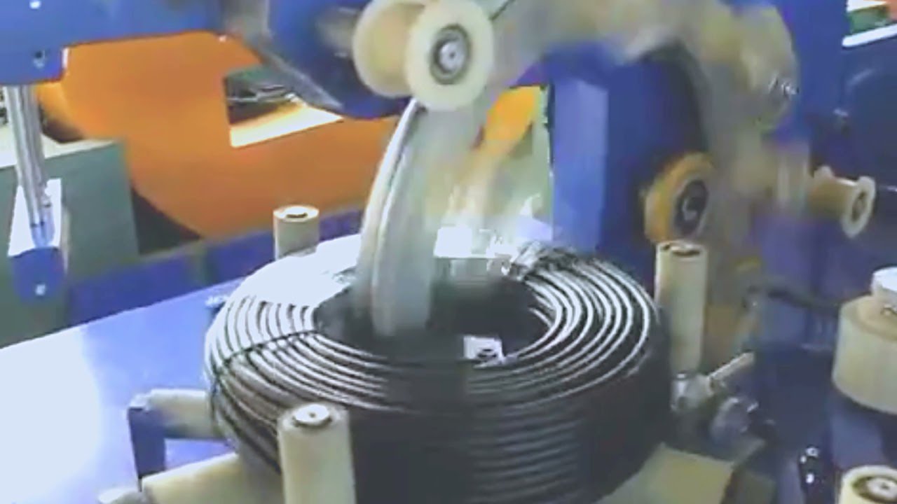 Electric cable wrapping machine with film wrapper for wire coils. Electric cable wrapping machine with film wrapper for wire coils.