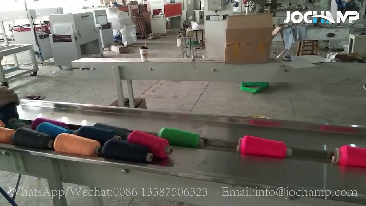 High-speed machine for packing wool coils automatically with shrink wrap during manufacturing process.