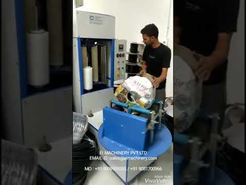 Machine for wrapping outer layer of flat drip pipe coil.