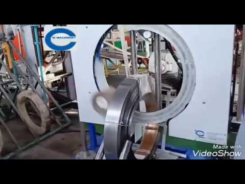 Motorized vertical steel coil wrapping machine with adjustable height.