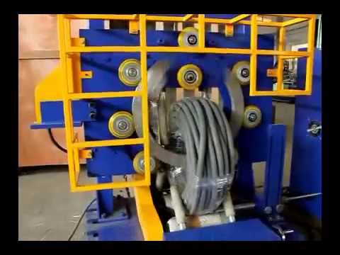 Packaging machine for coiled corrugated hoses and pipes.
