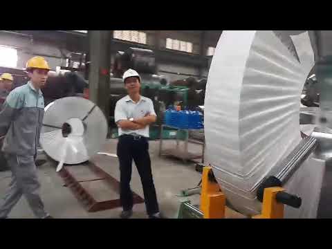 Packing machine for coiling items with optimized design for efficiency.