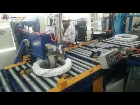 Steel strip coil packaging machine that operates automatically and efficiently.