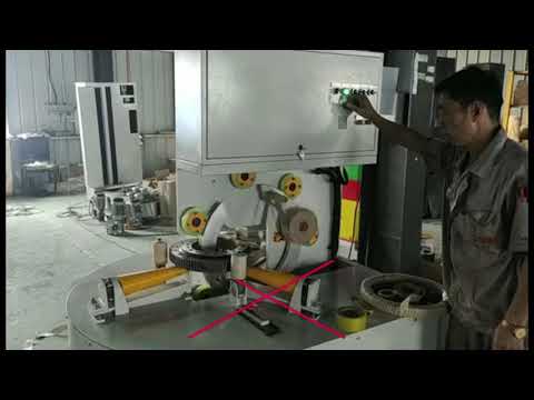 Vertical cable and tire packaging machine with coil wrapping capabilities.