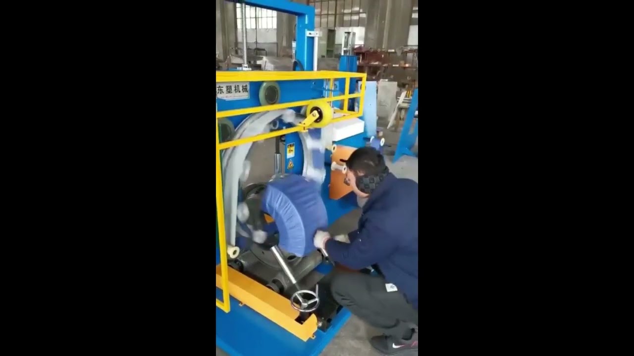 Vertical coil wrapping machine for pipes, cables, and steel wires. Vertical coil wrapping machine for pipes, cables, and steel wires.