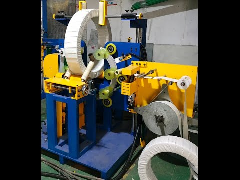 Vertical packing machine for steel wire coils.