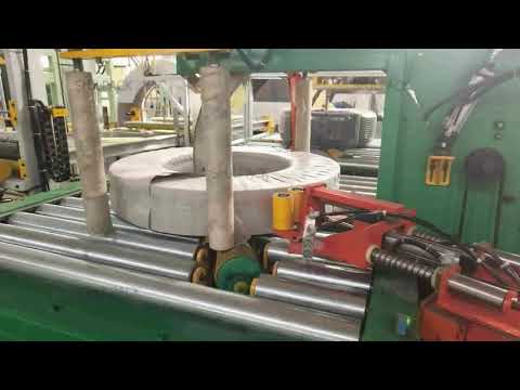 Wrapping and packing machine for steel coils with tape. Optimized design for efficient operation.