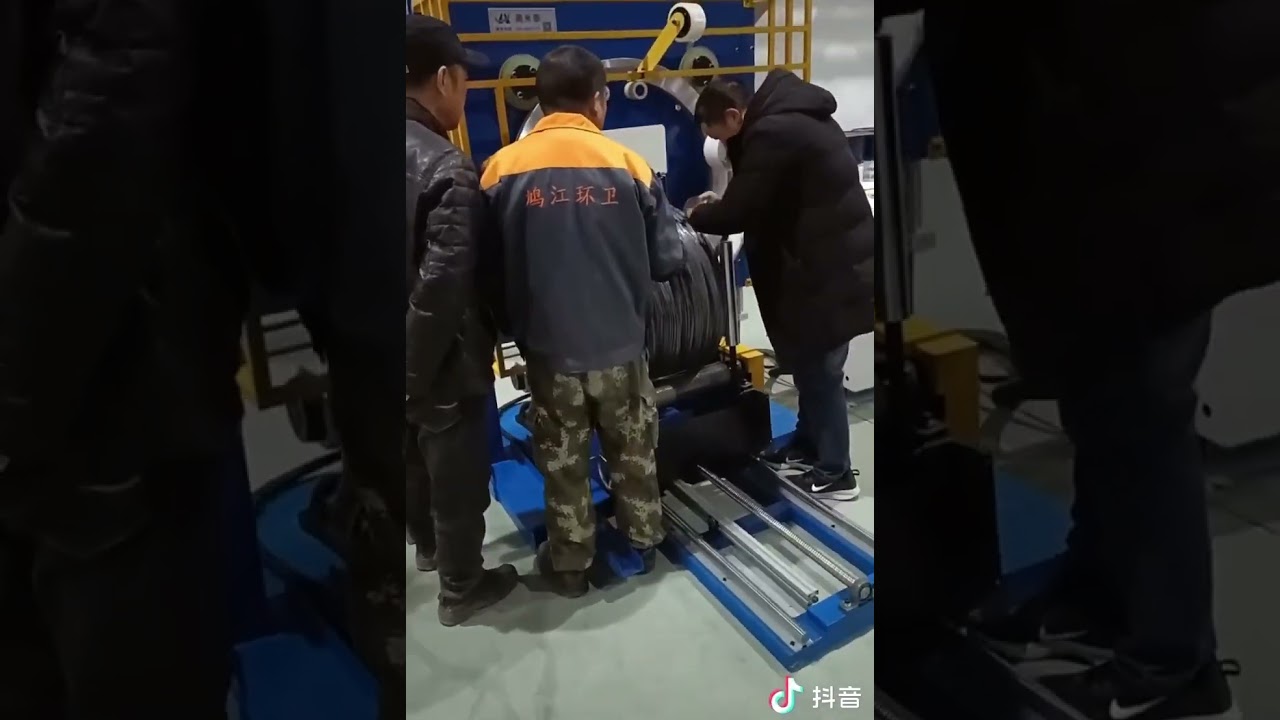 “Efficient Packing Machine for Coils: Enhanced and Streamlined”