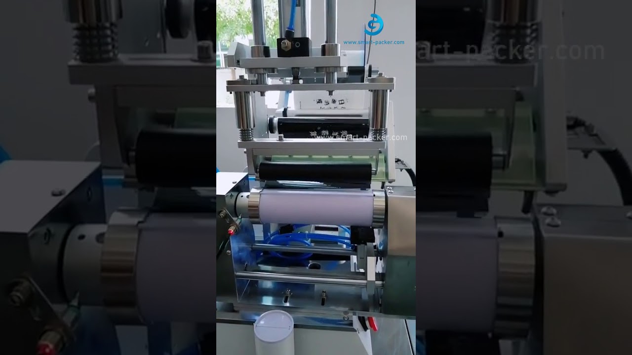 Tube hose rolling labeling machine for bottles, with semi-automatic operation.