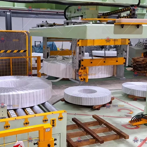 Steel coil packing line — The palletizer closes the line; its interface with the wrapper and the safety fence is part of the battery-limit schedule.